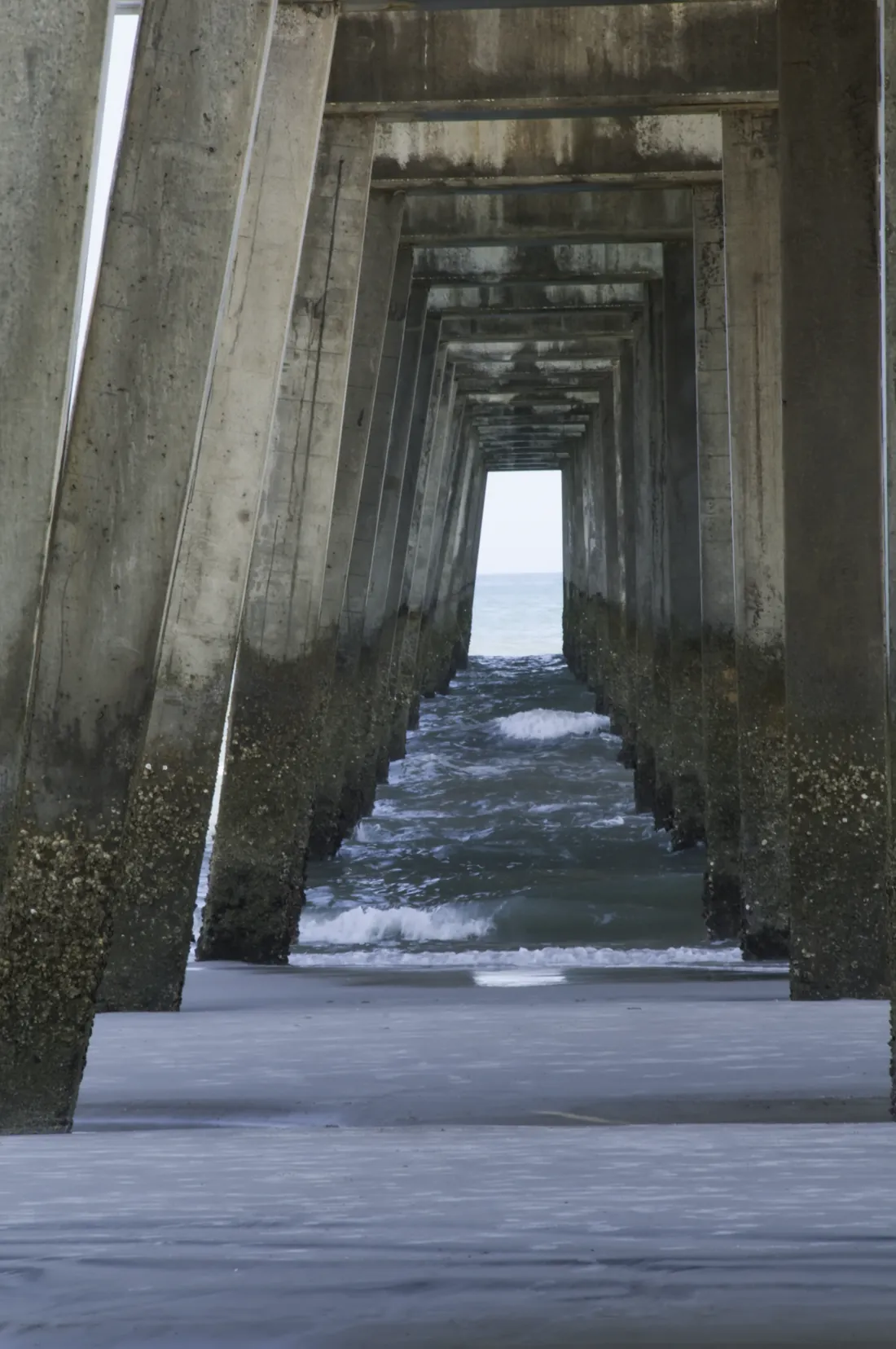Looking out to the ocean from beneath the pilings of the Jacksonville Beach pier