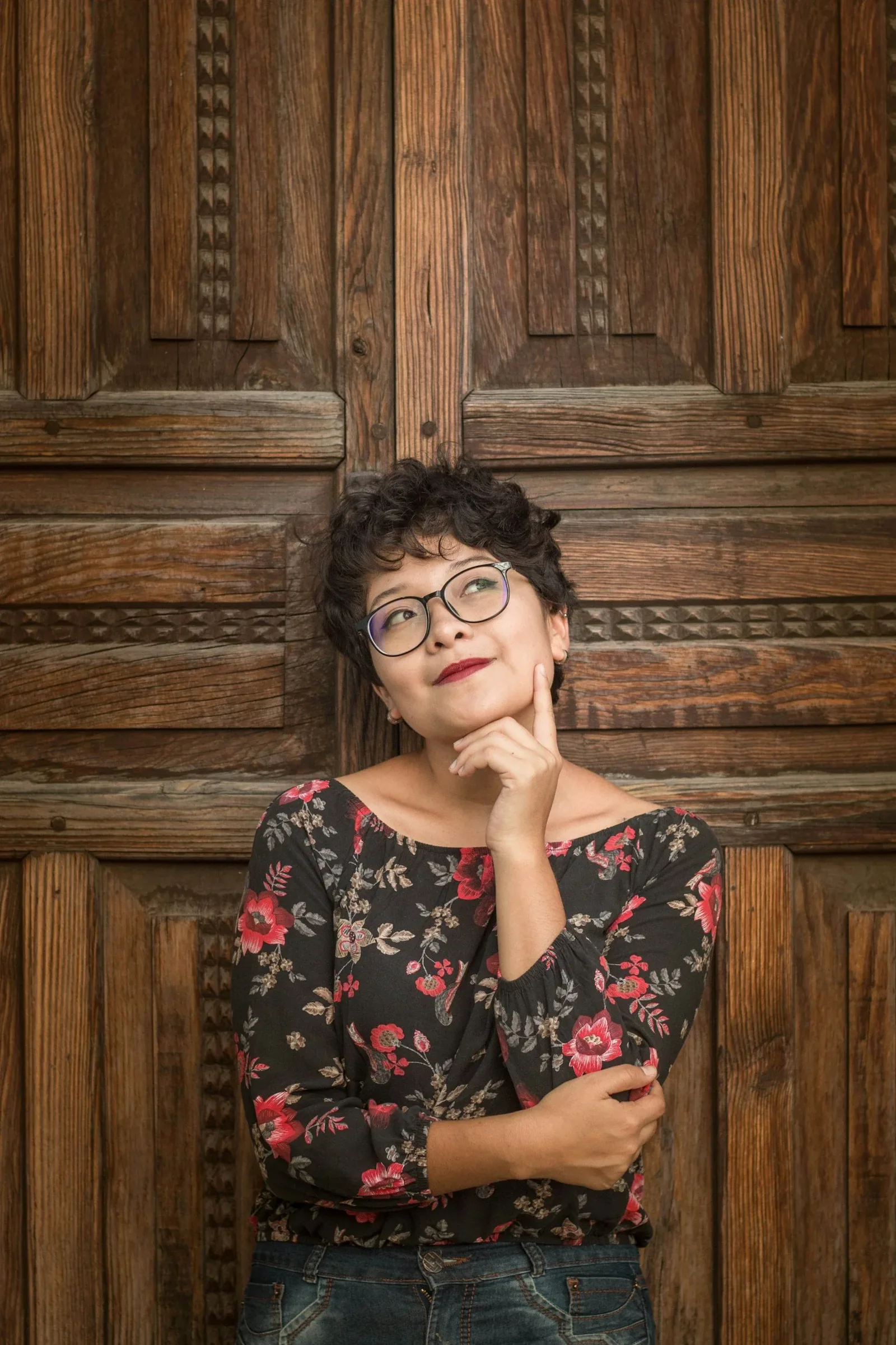 A person standing thoughtfully in a doorway, considering a decision