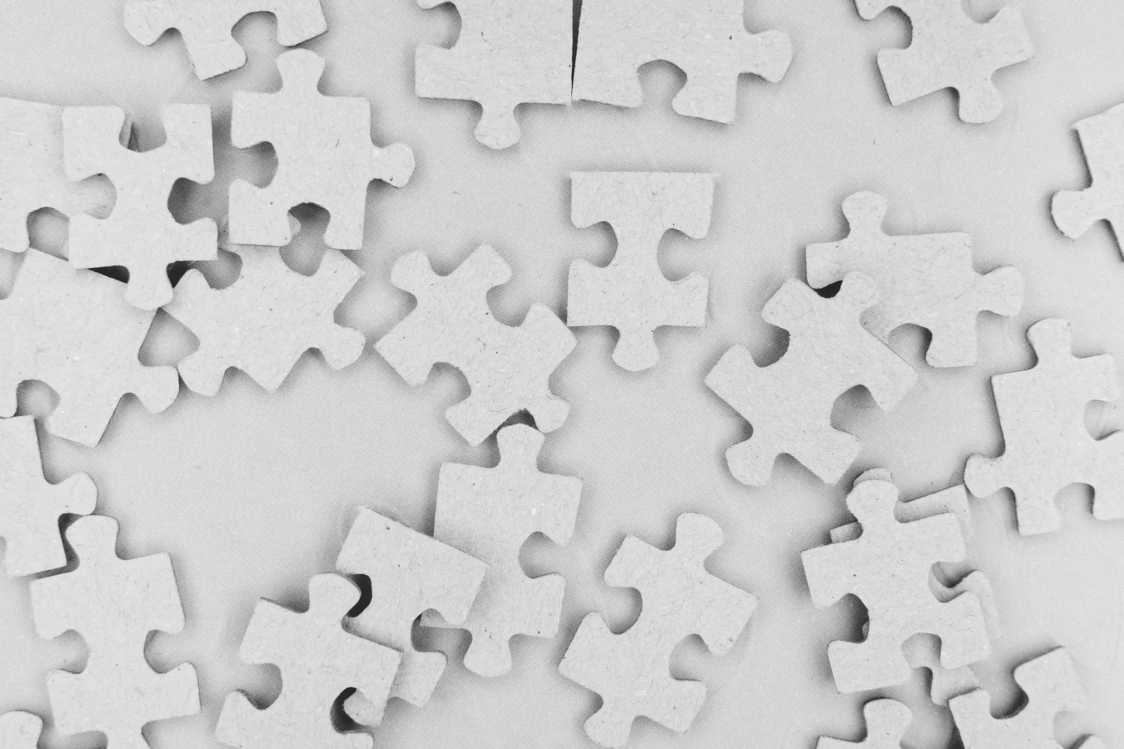 Interlocking white puzzle pieces fitted together