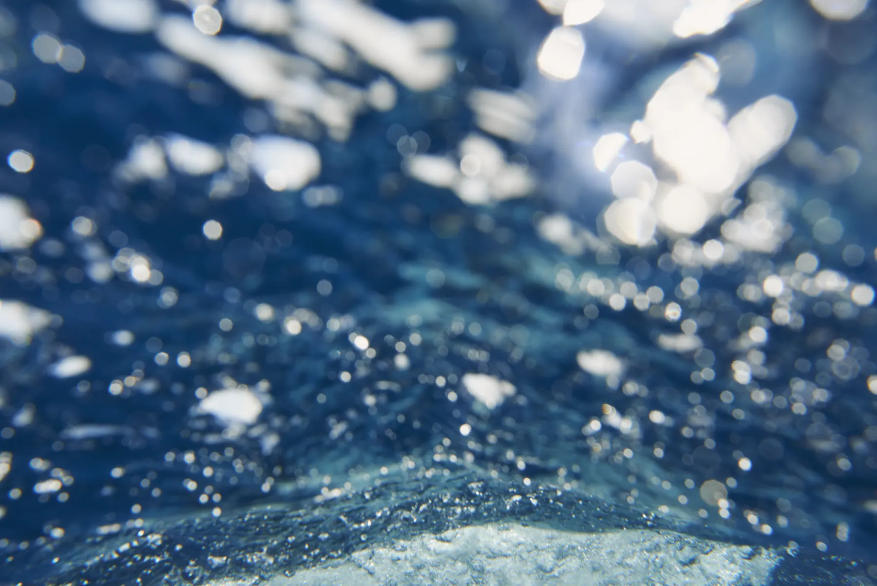 Water breaking over the surface of a pool